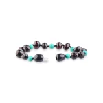 Handmade bracelet with dark almond beads and vibrant turquoise accents for stylish elegance.