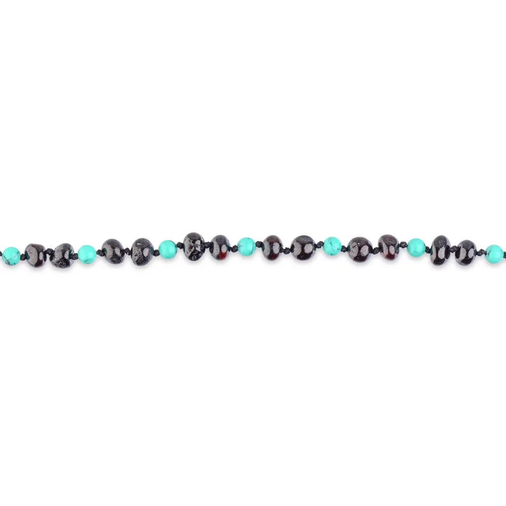 Black glossy beads with vibrant turquoise accents in a stylish handcrafted jewelry piece.
