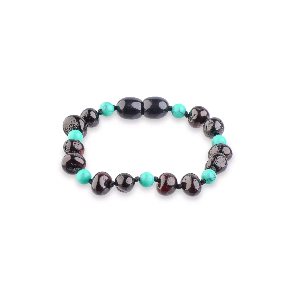Elegant black and turquoise beaded bracelet with natural textured stones and contrasting polished finishes.