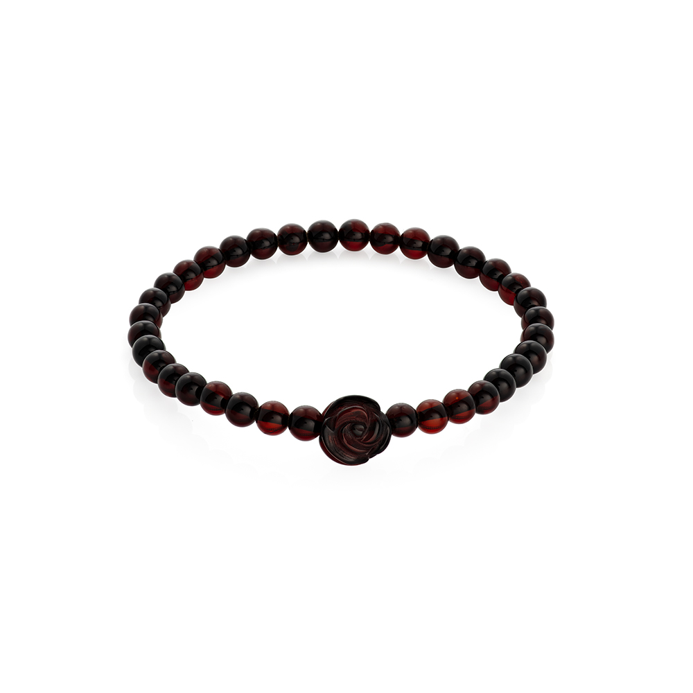 stylish polished light cherry color sphere natural amber bracelet with a rose, hand crafted, on a woman's arm