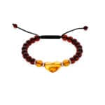 Handmade amber and dark bead bracelet with heart-shaped amber centerpiece and adjustable black cord.
