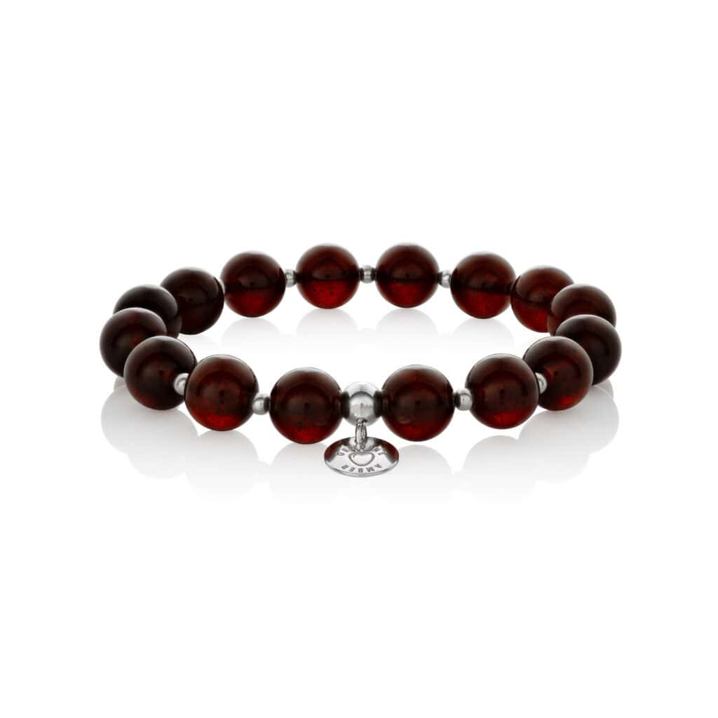 Elegant red beaded bracelet with silver accents and intricate charm, perfect for versatile styling.