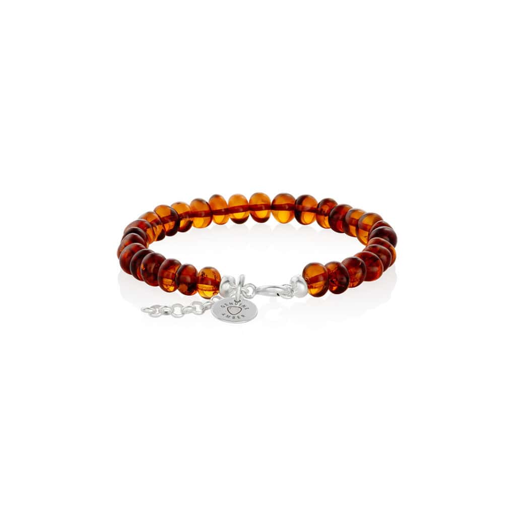 Elegant amber bead bracelet with silver clasp, handcrafted, warm cognac tones, versatile jewelry accessory.
