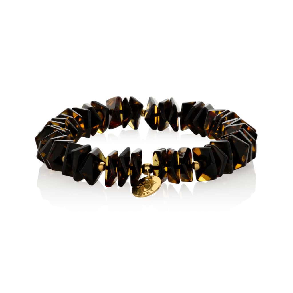 Bright tortoiseshell bracelet with gold charm, featuring geometric shapes and polished finish.