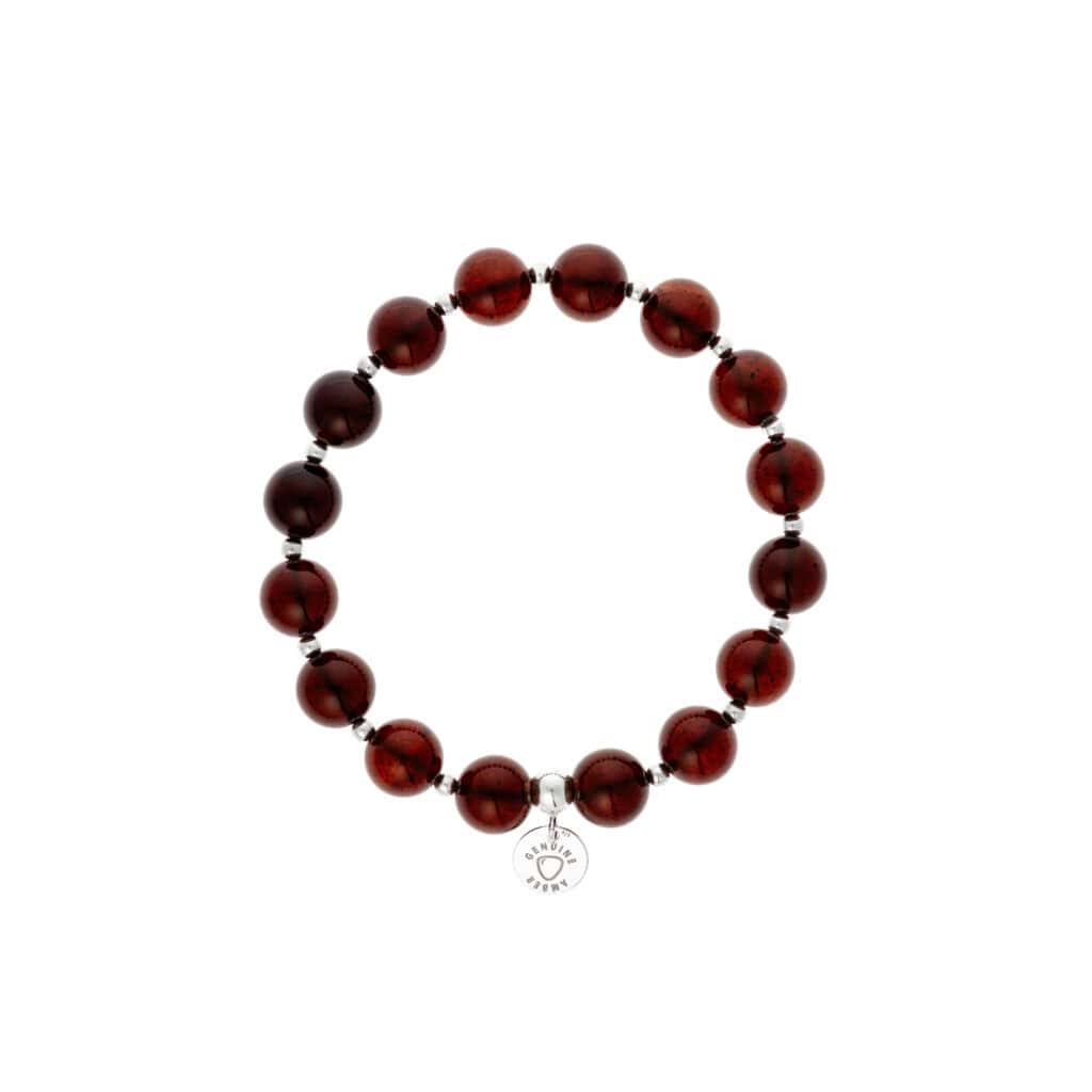 Elegant Baltic amber beaded bracelet with black spacer beads and intricate charm pendant.