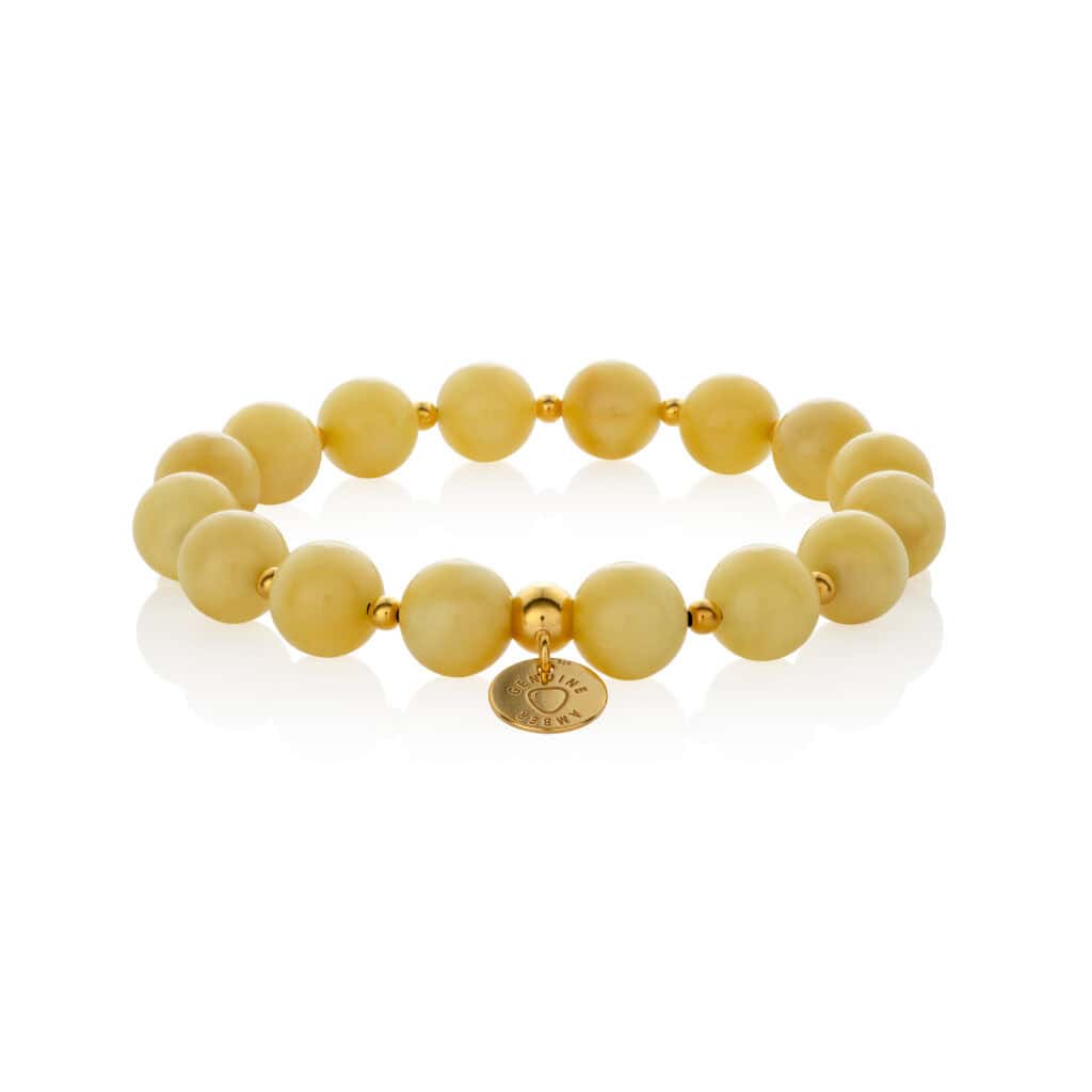 Elegant yellow beaded bracelet with gold accents and a detailed charm for versatile style.