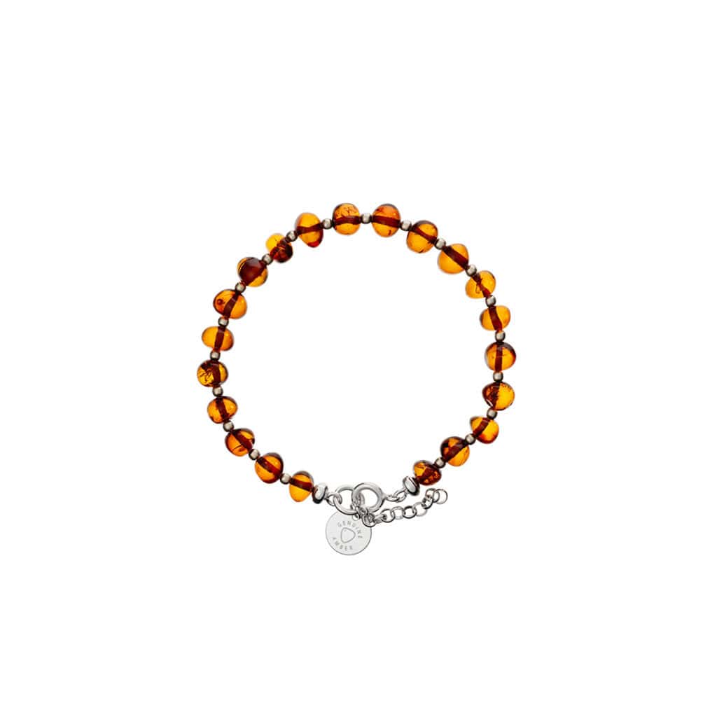 Handmade amber beaded bracelet with silver charm and adjustable chain for elegant natural style.