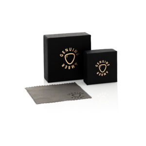 Luxury black boxes with gold Genuine emblem and soft gray cleaning cloth on a clean background.