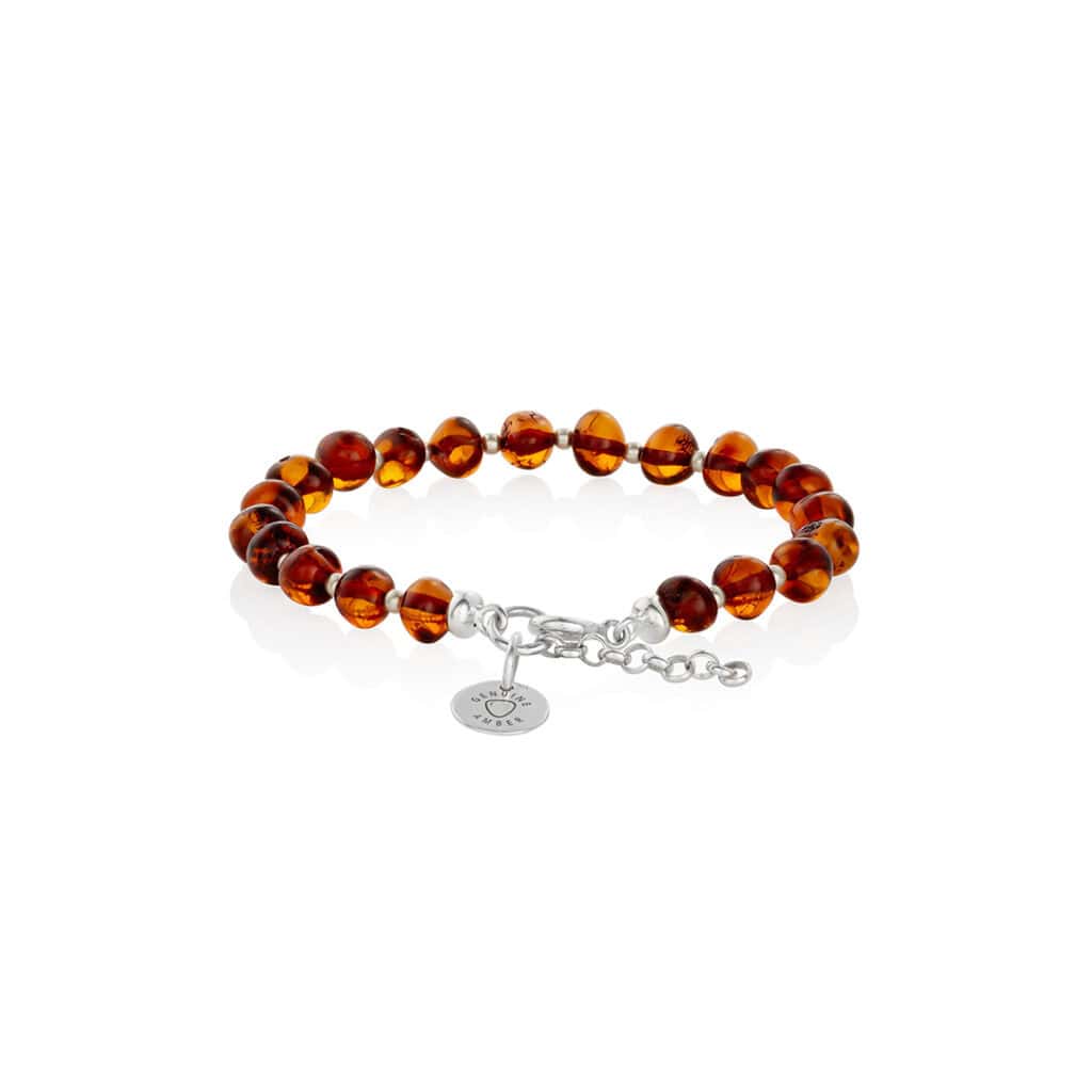 Handmade amber bracelet with silver accents and adjustable chain for elegant, natural style.