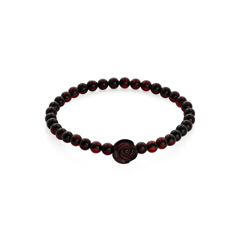 Elegant dark bead bracelet with intricate rose charm, handcrafted, perfect for stylish everyday wear.