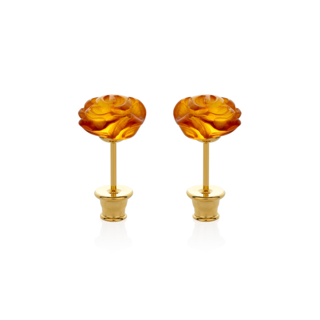 Close-up image of genuine cognac amber rose earrings, featuring warm, honey-brown amber stones intricately carved into the shape of roses. The translucent amber showcases natural inclusions, adding depth and character to the delicate floral design. Set in polished silver, these earrings blend the organic beauty of amber with the elegance of a rose motif.