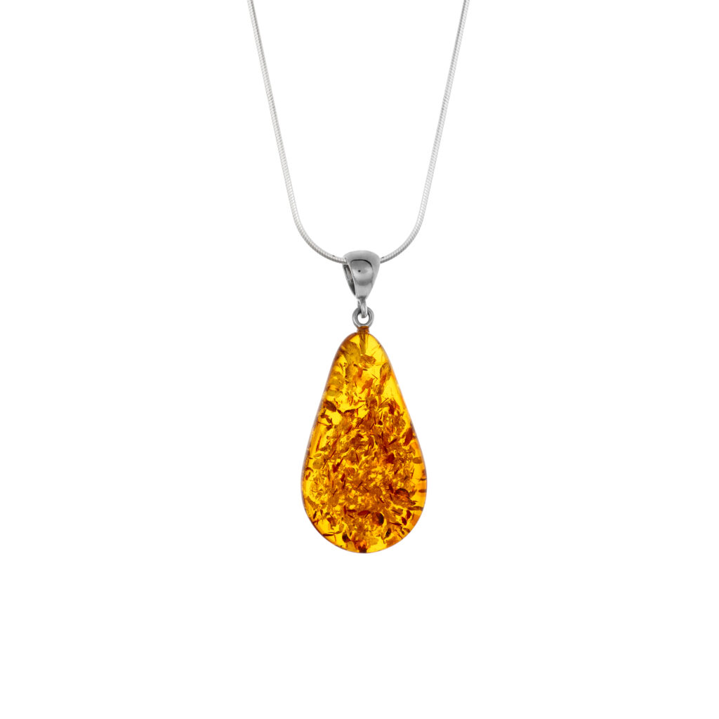 A close-up image of a genuine amber pendant showcasing its warm, golden hues. The amber is transparent with natural inclusions, capturing its organic beauty. The pendant is encased in a silver or gold frame, adding elegance to the raw, fossilized resin. The smooth surface of the amber reflects light, highlighting its natural glow and intricate details. This timeless piece of jewelry hangs delicately from a chain, blending nature and craftsmanship.