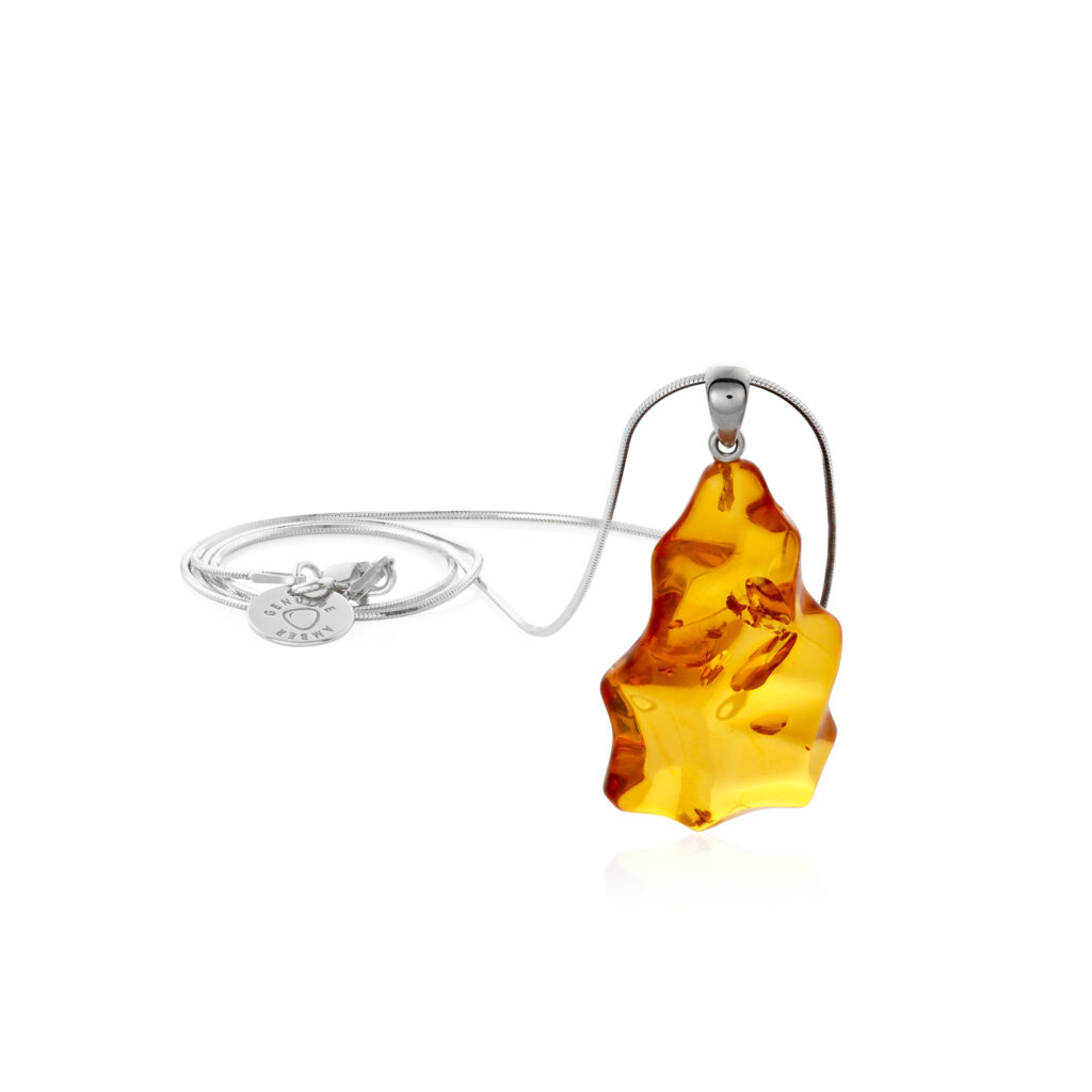 Unique-shaped Baltic amber pendant with uneven edges, paired with a sterling silver chain