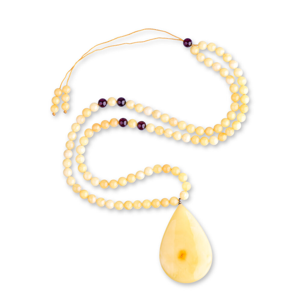 A genuine amber necklace featuring butter-colored beads with a soft, creamy yellow tone. The beads are smooth and slightly translucent, with delicate inclusions that highlight the natural origin of the amber. The necklace exudes a warm, gentle glow, showcasing the unique and organic beauty of the butter-colored amber.