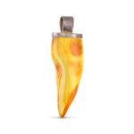 A close-up image of a genuine amber pendant showcasing its warm, golden hues. The amber is transparent with natural inclusions, capturing its organic beauty. The pendant is encased in a silver or gold frame, adding elegance to the raw, fossilized resin. The smooth surface of the amber reflects light, highlighting its natural glow and intricate details. This timeless piece of jewelry hangs delicately from a chain, blending nature and craftsmanship.