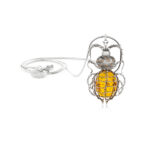 Sterling silver and gold beetle pendant with a large amber stone, showcasing intricate craftsmanship and natural inclusions