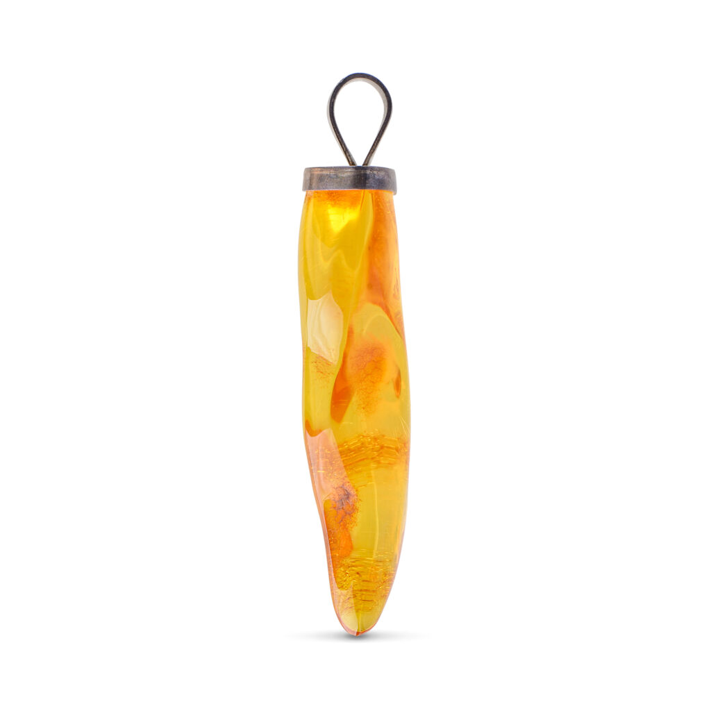 A close-up image of a genuine amber pendant showcasing its warm, golden hues. The amber is transparent with natural inclusions, capturing its organic beauty. The pendant is encased in a silver or gold frame, adding elegance to the raw, fossilized resin. The smooth surface of the amber reflects light, highlighting its natural glow and intricate details. This timeless piece of jewelry hangs delicately from a chain, blending nature and craftsmanship.