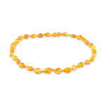 A collection of genuine amber necklaces, featuring beads in various shades from deep honey to creamy butter. Each necklace showcases the natural beauty of amber, with smooth, polished beads that highlight unique inclusions and subtle color variations. The necklaces are elegantly crafted, offering a timeless and organic accessory choice.