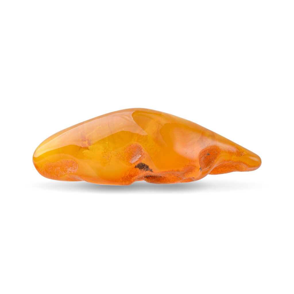 The amber piece displayed from above, showing its overall size and the warm, golden glow it emits.