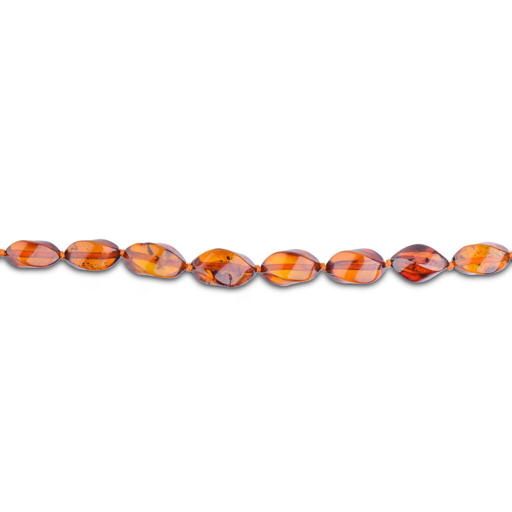 A collection of genuine amber necklaces, featuring beads in various shades from deep honey to creamy butter. Each necklace showcases the natural beauty of amber, with smooth, polished beads that highlight unique inclusions and subtle color variations. The necklaces are elegantly crafted, offering a timeless and organic accessory choice.