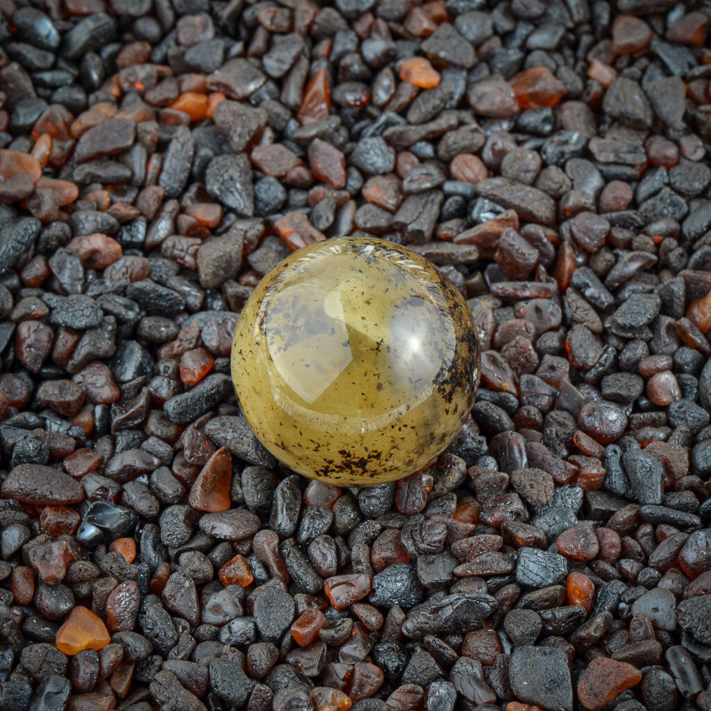 Detailed close-up of the green Baltic amber, focusing on the unique color variations and texture.