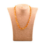 A collection of genuine amber necklaces, featuring beads in various shades from deep honey to creamy butter. Each necklace showcases the natural beauty of amber, with smooth, polished beads that highlight unique inclusions and subtle color variations. The necklaces are elegantly crafted, offering a timeless and organic accessory choice.