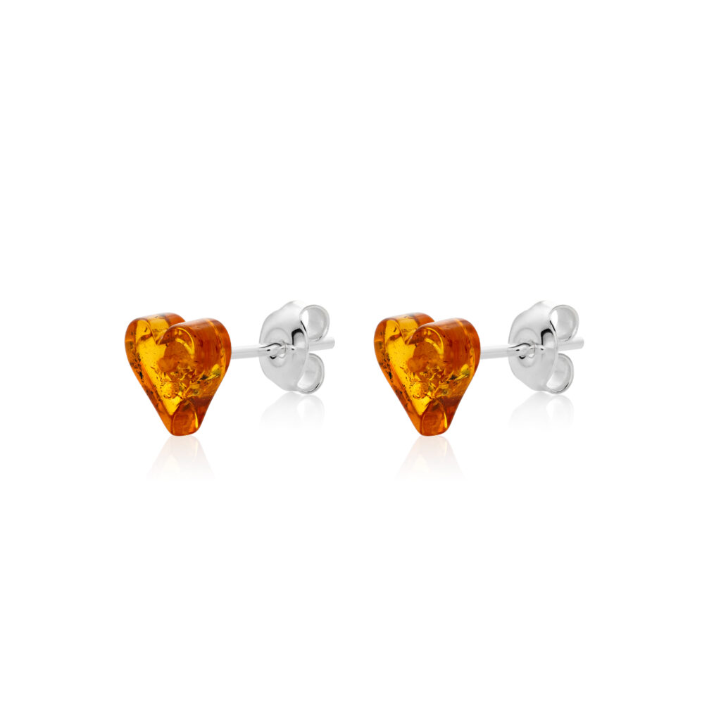 heart-shaped amber earrings set in sterling silver. The color is rich cognac.