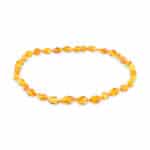 Elegant amber beaded necklace with glossy oval honey-toned stones, perfect for stylish everyday wear.