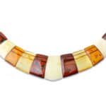 Handmade Baltic amber necklace with natural inclusions in warm amber tones, elegant craftsmanship.