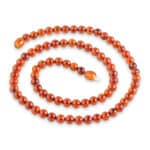 Elegant Baltic amber necklace with honey-colored beads and intricate clasp for versatile style.