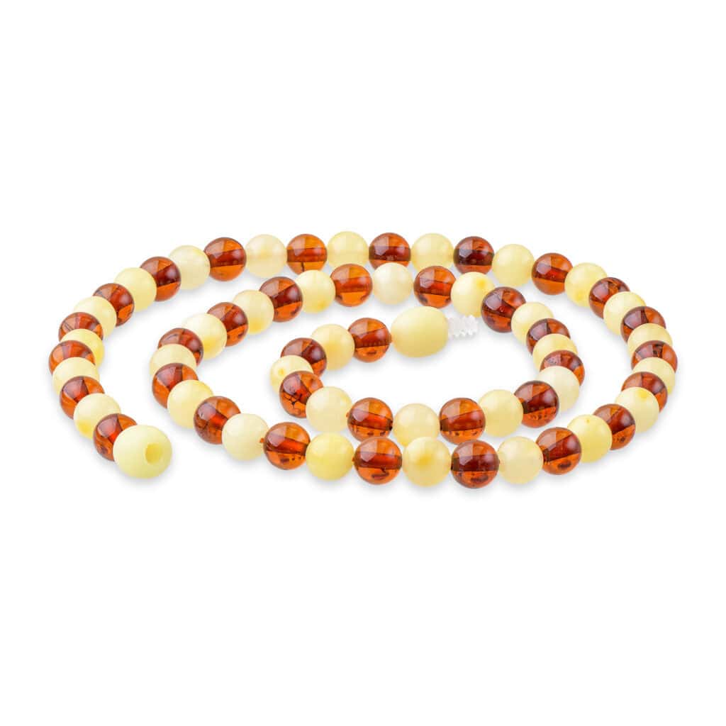 Elegant Baltic amber and ivory beaded necklace with polished, contrasting, and beautifully arranged beads.