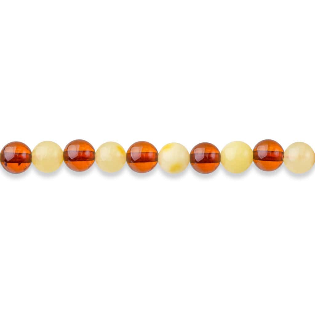 Row of smooth, dual-tone amber beads with glossy finish for jewelry or craft projects.