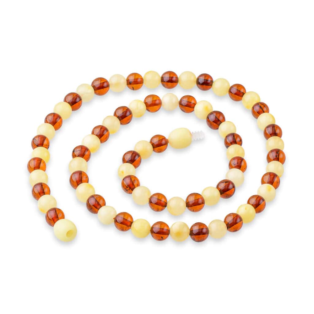 Elegant Baltic amber necklace with alternating amber and creamy beads, timeless and versatile jewelry piece.