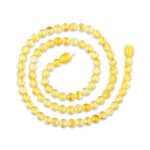Handmade yellow amber beaded necklace with polished, gradient beads and a textured focal bead.