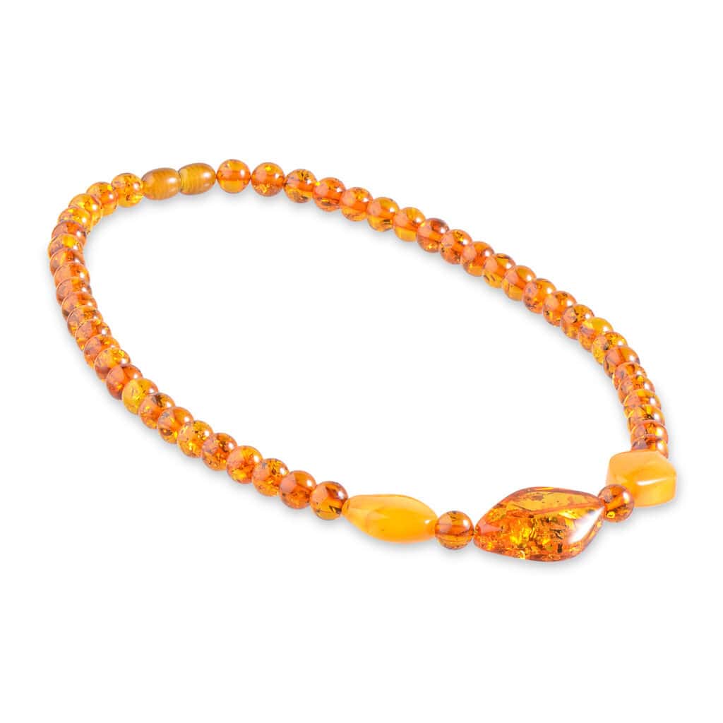 Handmade Baltic amber necklace with honey tones and diverse shaped beads for casual or elegant wear.