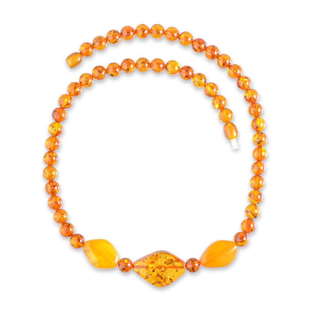 Handmade amber necklace with central patterned bead and warm honey-colored Baltic amber accents.