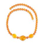 Handmade amber necklace with central patterned bead and warm honey-colored Baltic amber accents.