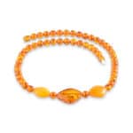 Vibrant amber necklace with marquise centerpiece and round beads in warm orange tones
