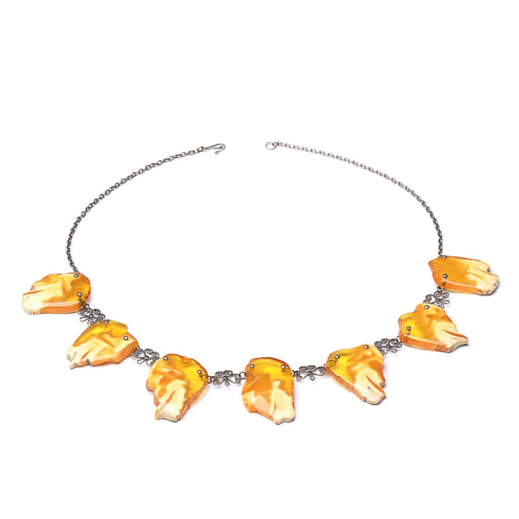 Elegant Baltic amber necklace with leaf-shaped pendants and a delicate silver chain.