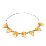 Elegant Baltic amber necklace with leaf-shaped pendants and a delicate silver chain.