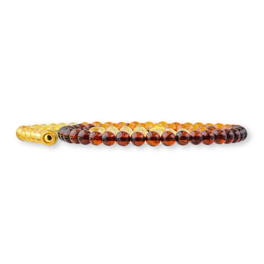 Polished amber bracelet with gold clasp, warm gradient beads, elegant handmade jewelry for any occasion.