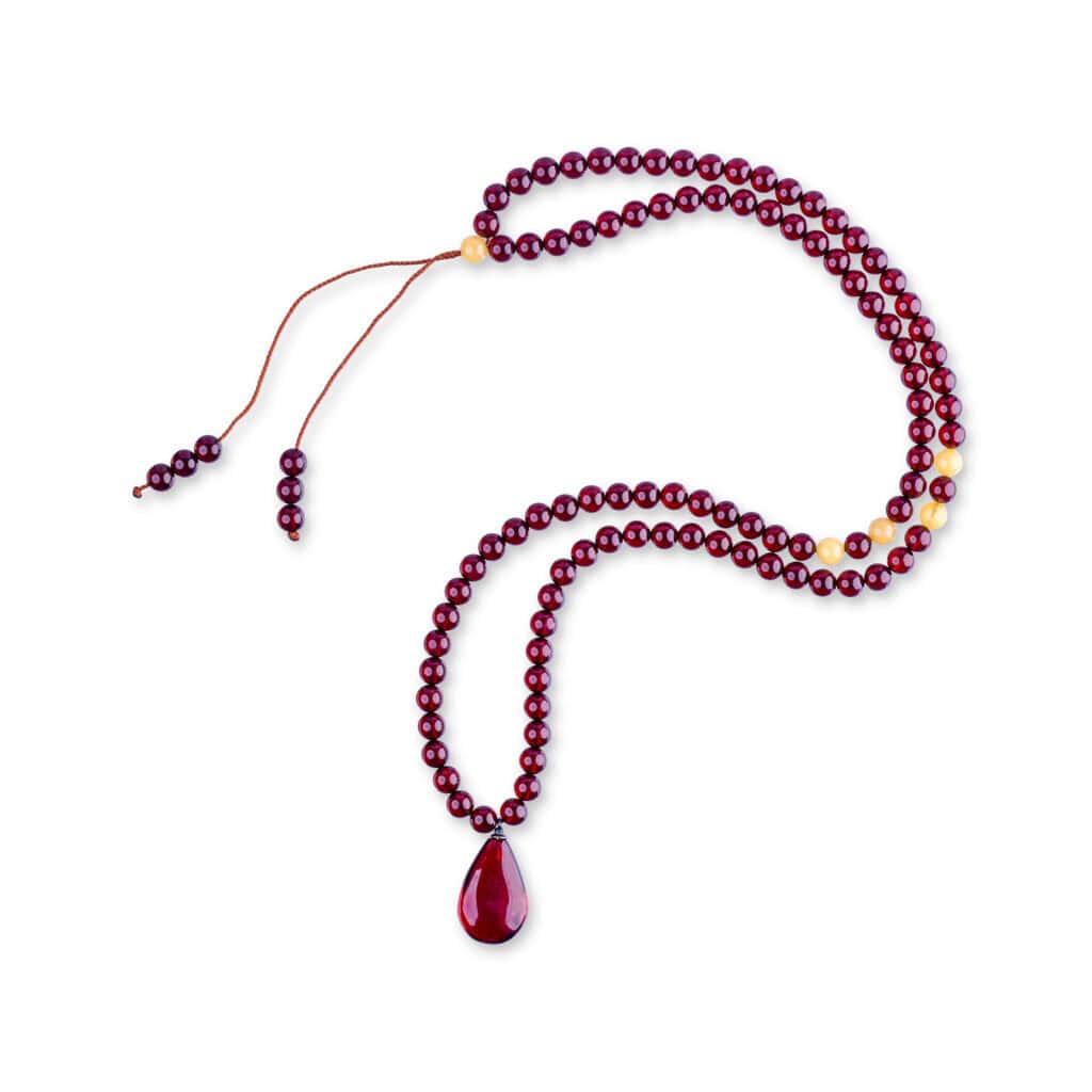 Elegant cherry-colored Baltic amber mala necklace with teardrop pendant and golden accent beads.