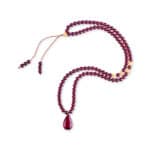 Elegant cherry-colored Baltic amber mala necklace with teardrop pendant and golden accent beads.