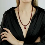 Elegant Baltic amber necklace with teardrop pendant, handcrafted in rich cherry tones for sophisticated style.