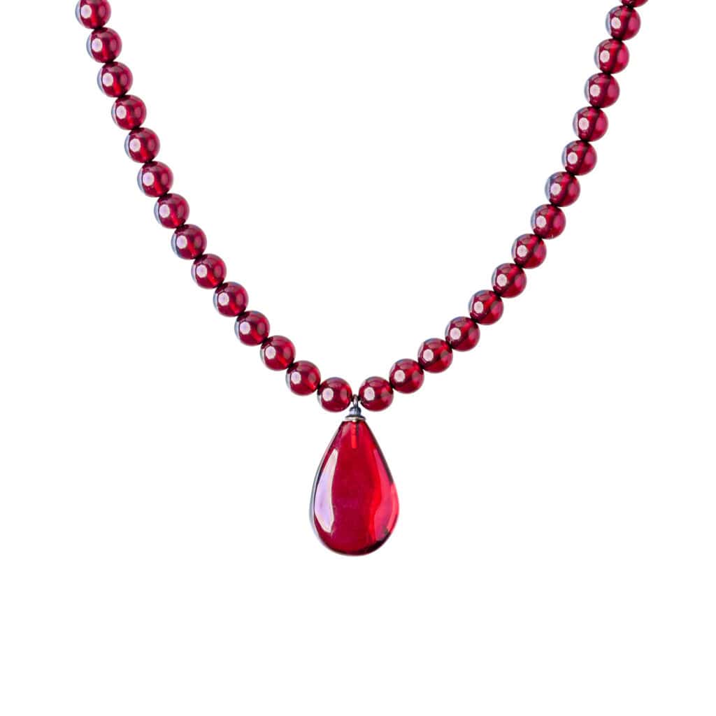 Elegant red Baltic amber necklace with teardrop pendant, handcrafted and perfect for any occasion.