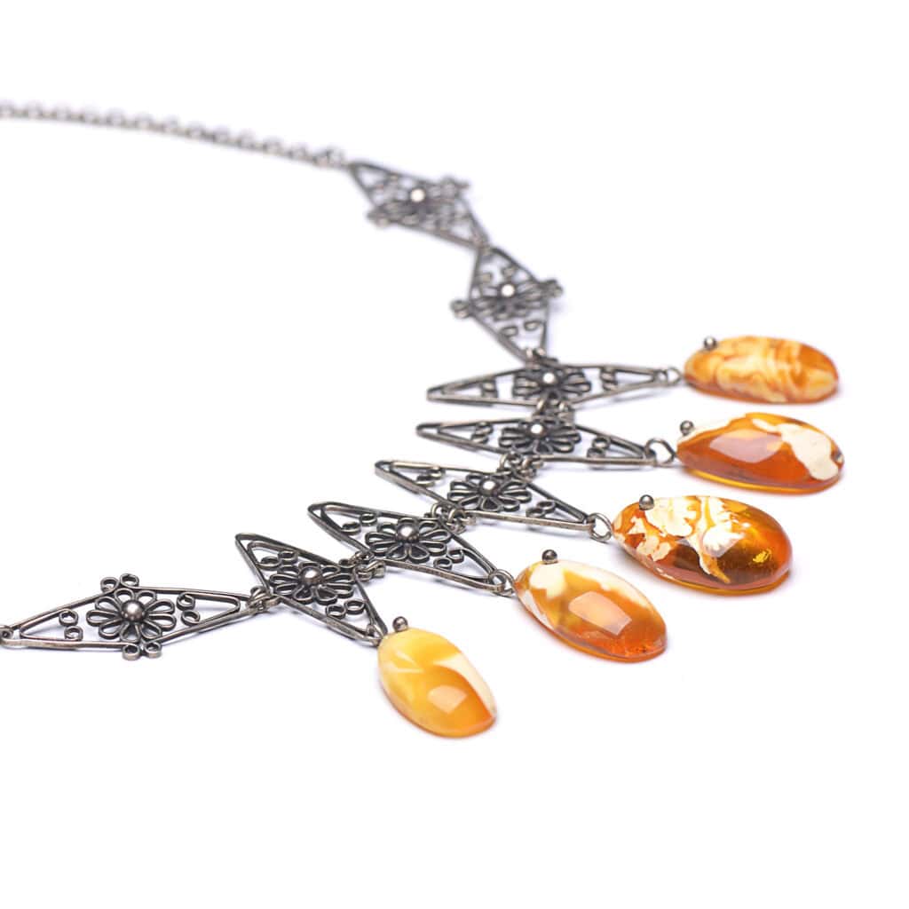 Vintage Baltic amber necklace with stylish metal flower accents, amber color is orange-yellow-white