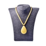 Elegant Baltic amber necklace with teardrop pendant on display, blending simplicity and sophisticated craftsmanship.