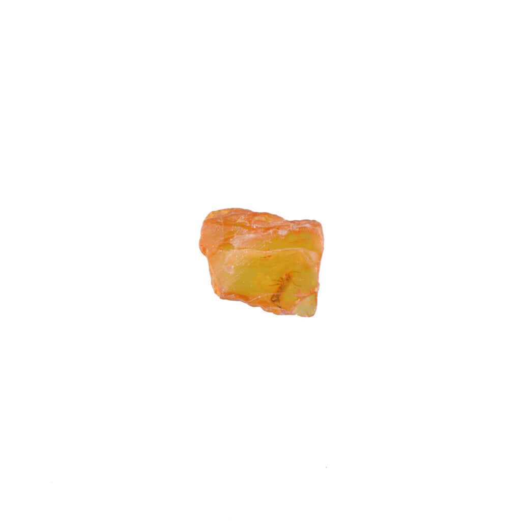 Natural golden stone with smooth, rounded edges and subtle translucency on a white background.
