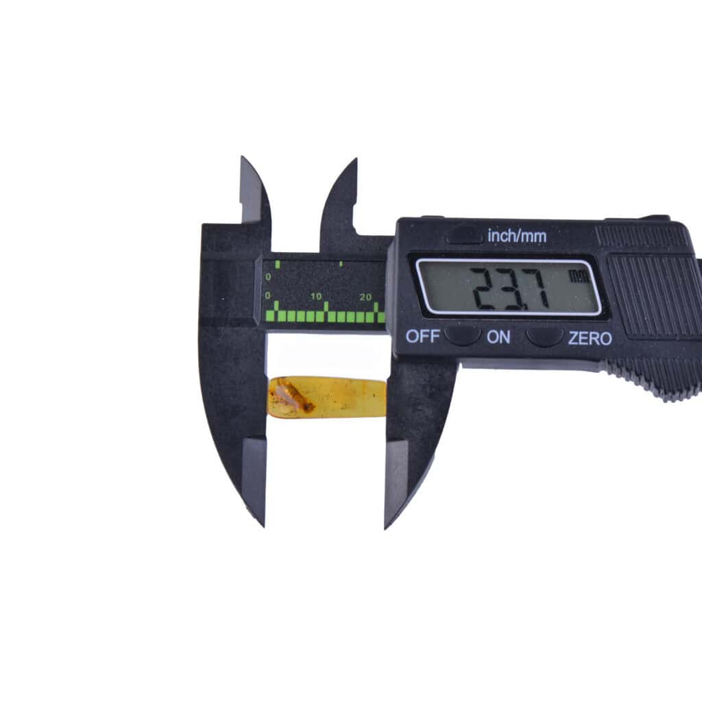 Digital caliper measuring a thin golden tape or film with a 23.7 mm reading.