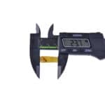 Digital caliper measuring a thin golden tape or film with a 23.7 mm reading.